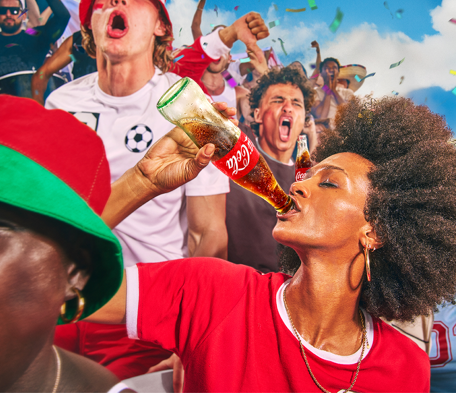 Coca-Cola soccer campaign banner featuring a woman drinking from a glass bottle amidst a cheering stadium crowd.