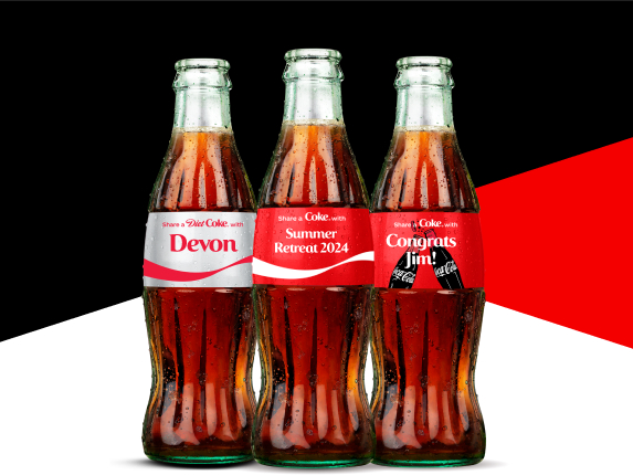 three various coke bottles with different names on labels