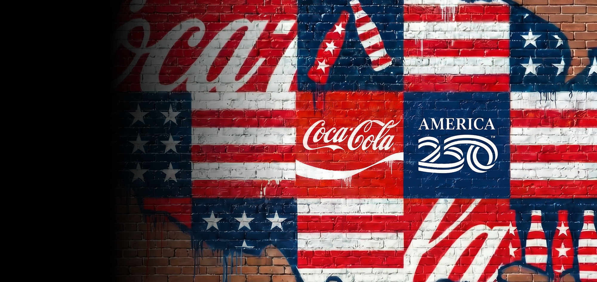 Patriotic brick wall mural featuring the Coca-Cola and America 250 logos with red, white, and blue flag map details.