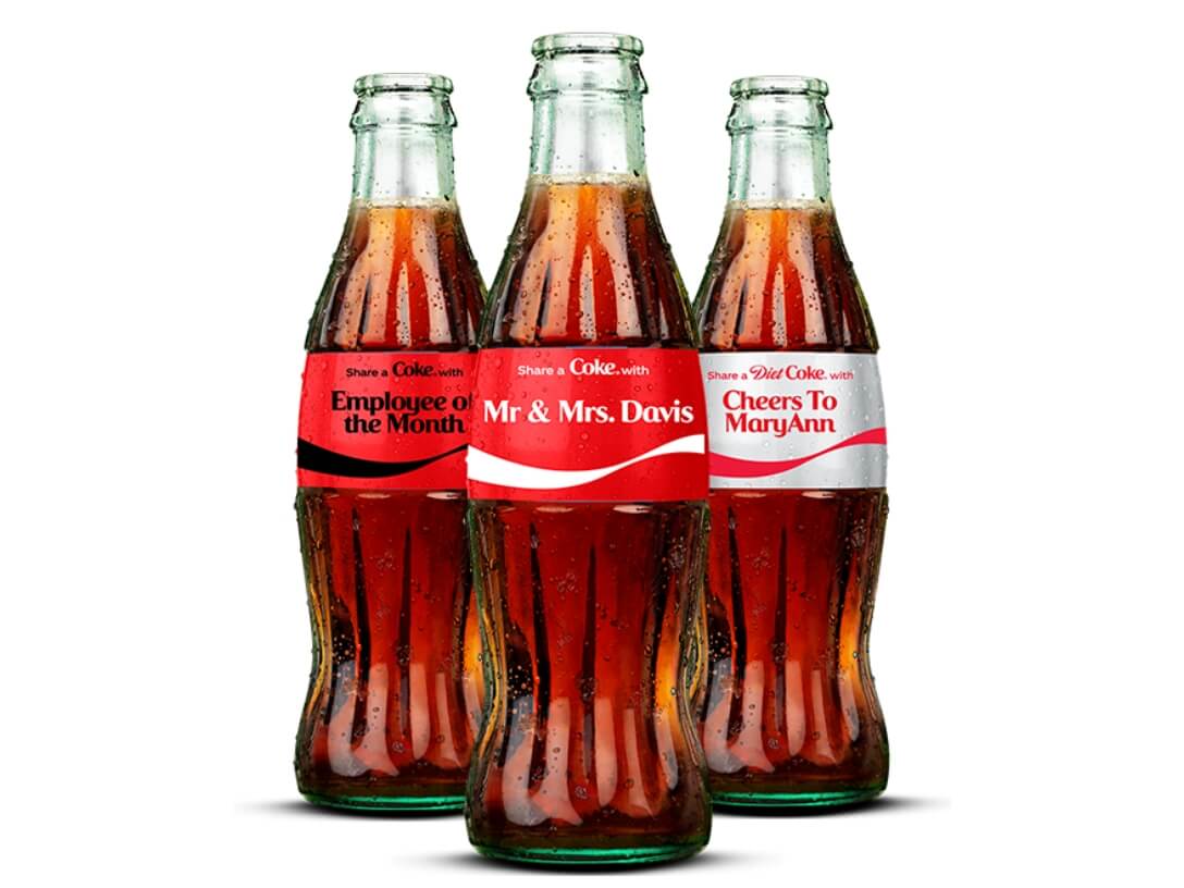Three custom Coca-Cola glass bottles 