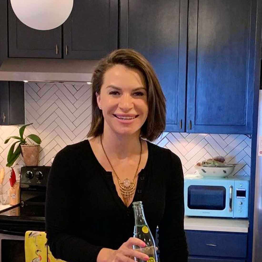 Wunderwell founder Lauren Hersh holding a Topo Chico bottle