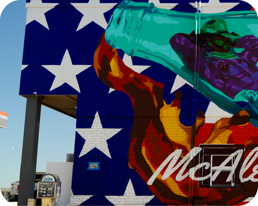 Close-up of Bailee Green's mural showing a painted cowboy relaxing inside a classic green Coca‑Cola contour bottle.