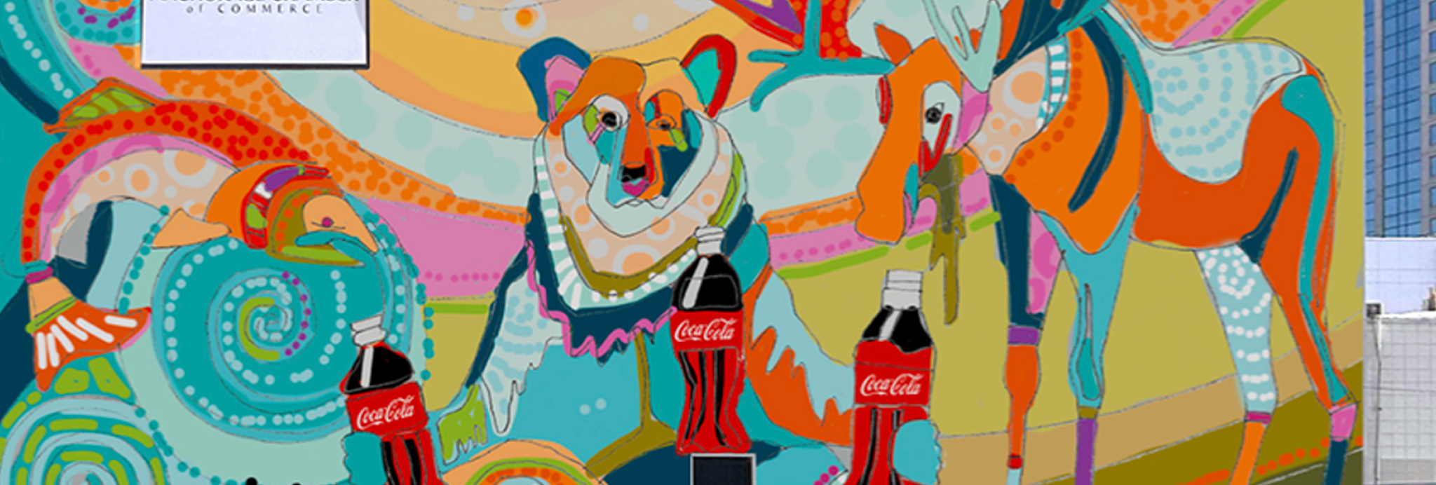 Vibrant pink and orange mural of two students clinking Coca‑Cola bottles, surrounded by flowers, Route 66 signage and campus landmarks.