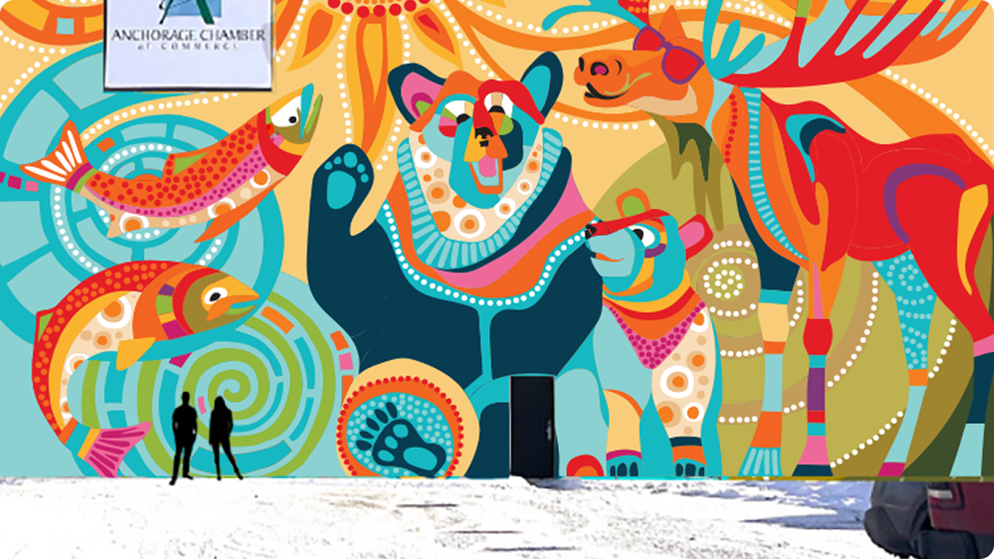 Wide shot of the vibrant Alaska-themed mural featuring a bear and moose, with two people standing in front.