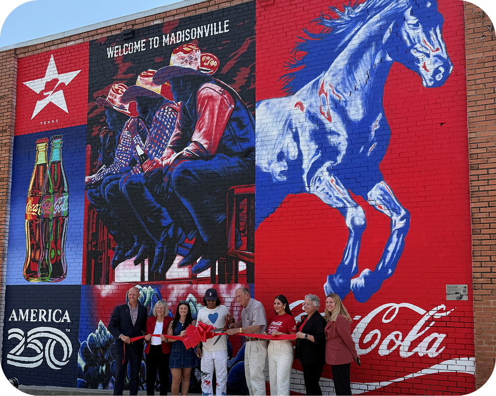 Ribbon-cutting ceremony in front of Gabriel Portillo's Texas-themed Coca‑Cola mural for Paint the Nation.