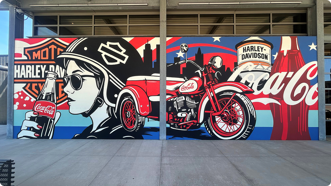 A vintage red motorcycle with the Coca-Cola logo on its tank, part of a patriotic mural by artist Greg Gossel.