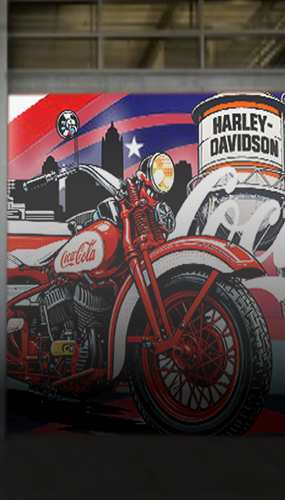 mural featuring vintage Coca-Cola motorcycle and Harley-Davidson sign against city skyline