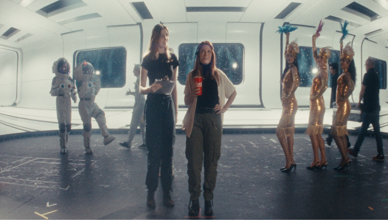 Behind the scenes on sci-fi movie set with Coca-Cola cup, astronauts and gold-costumed dancers for Cinemark Refreshing Films.