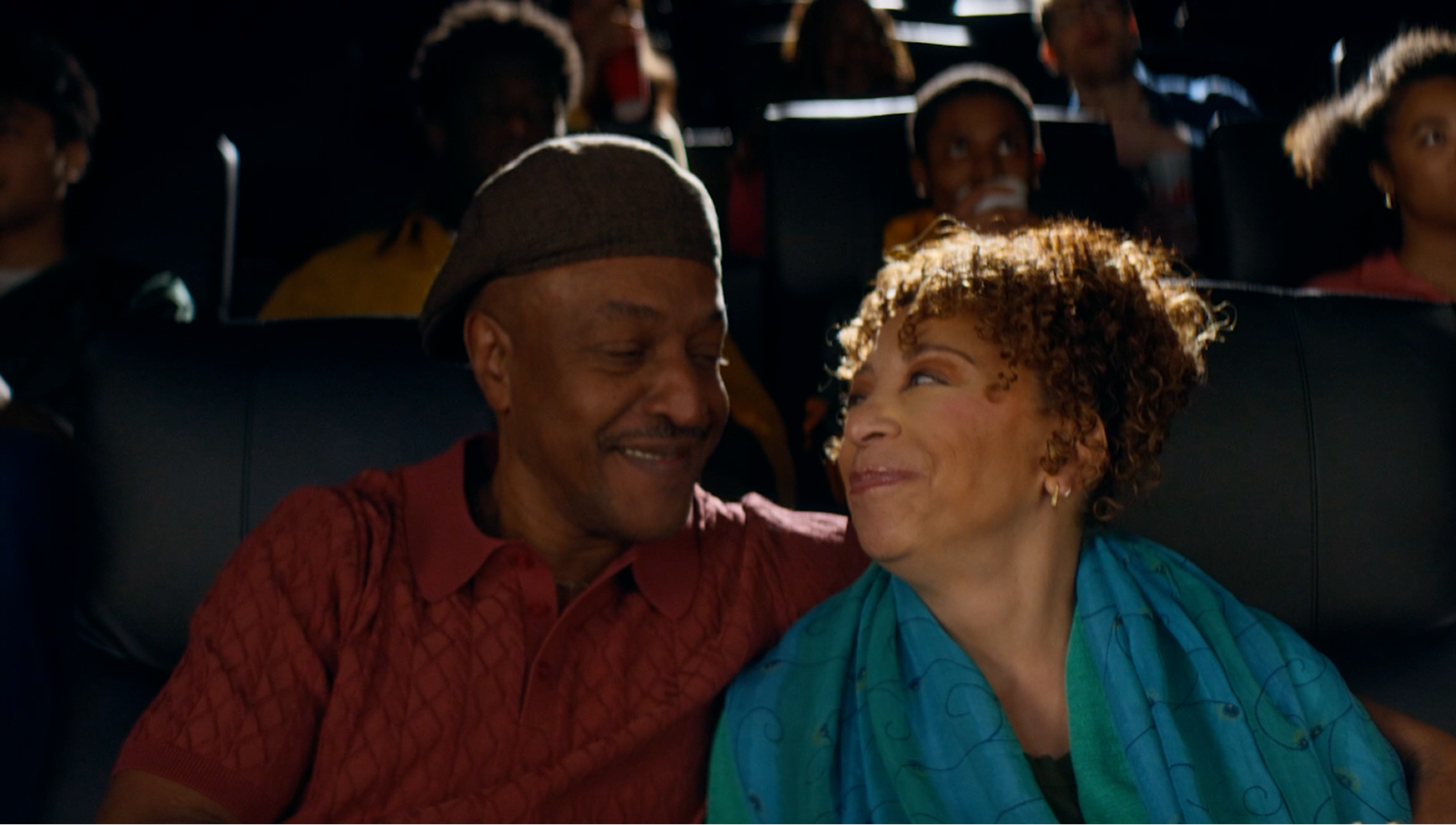Happy couple enjoying a movie together in Cinemark theater for Coca-Cola The Usual film spot.
