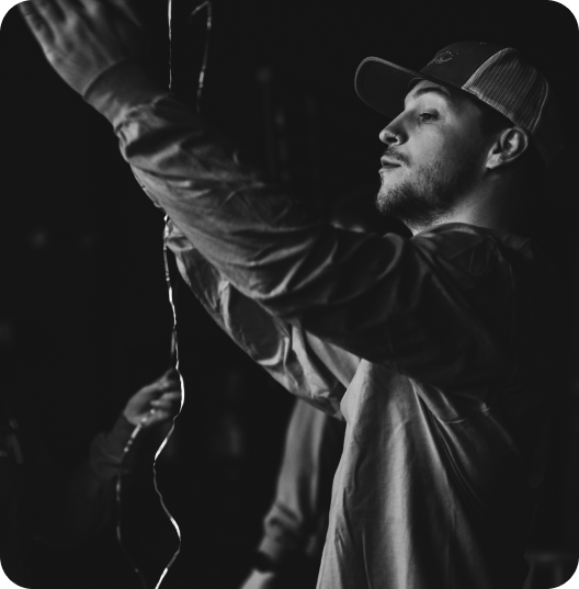 Black and white behind-the-scenes shot of crew member working on film set