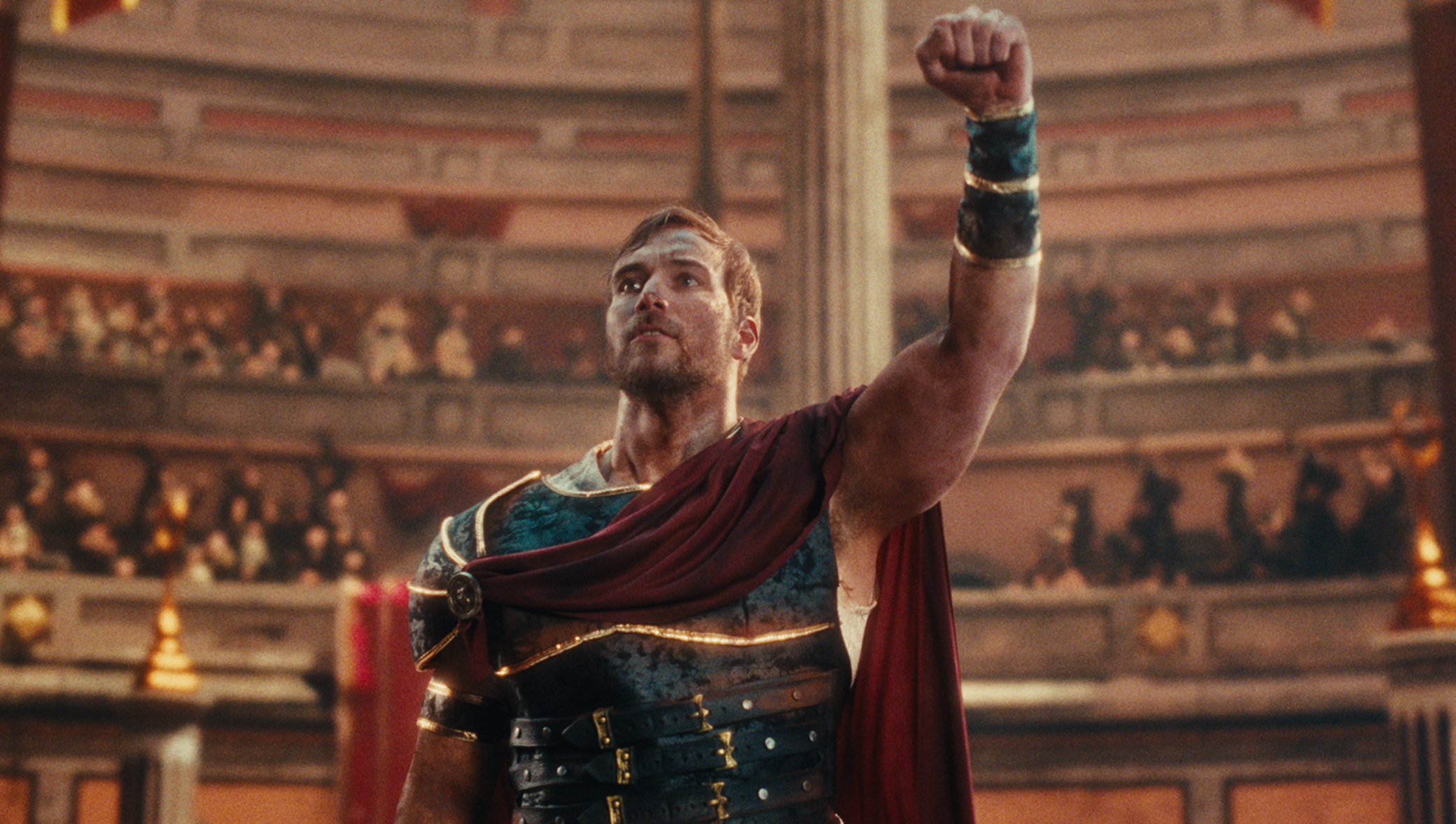 Heroic gladiator raising fist in crowded arena from Cinemark What Makes Them Magic film spot