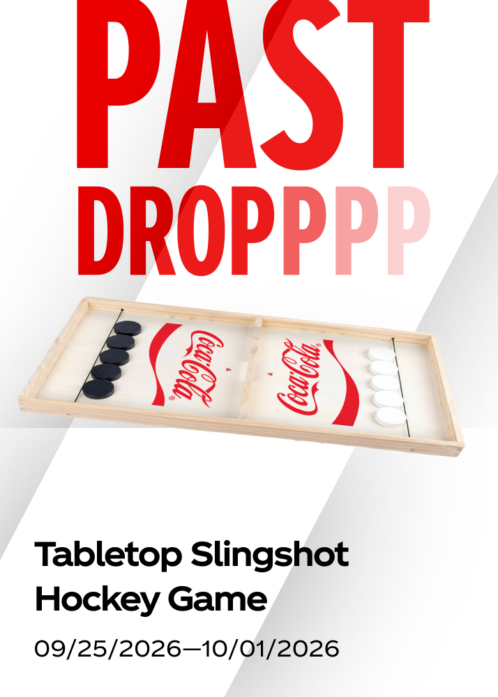 A wooden tabletop slingshot hockey game shown as a past drop for the Coca-Cola promo.