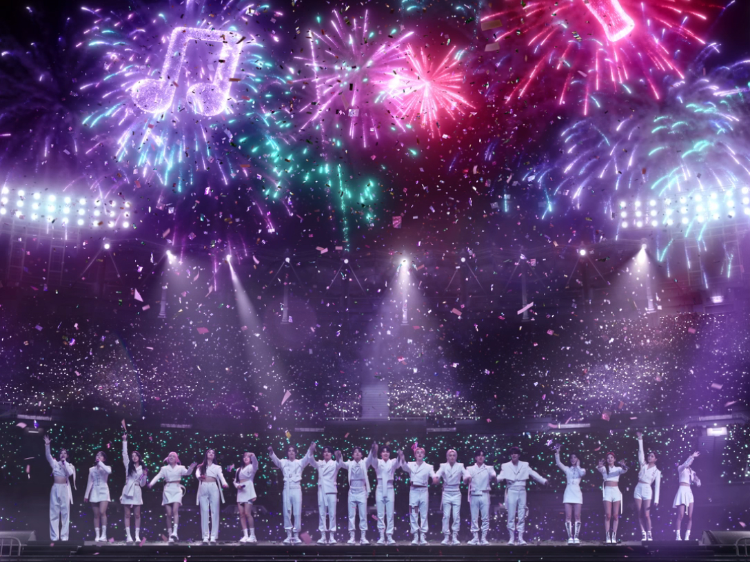 kpop bands standing beneath fireworks