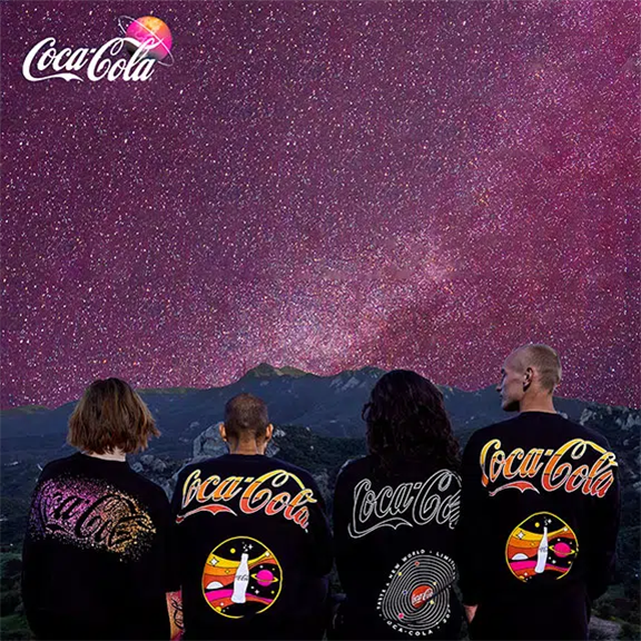 Four people gazing at a starfield in Coca-Cola themed jackets