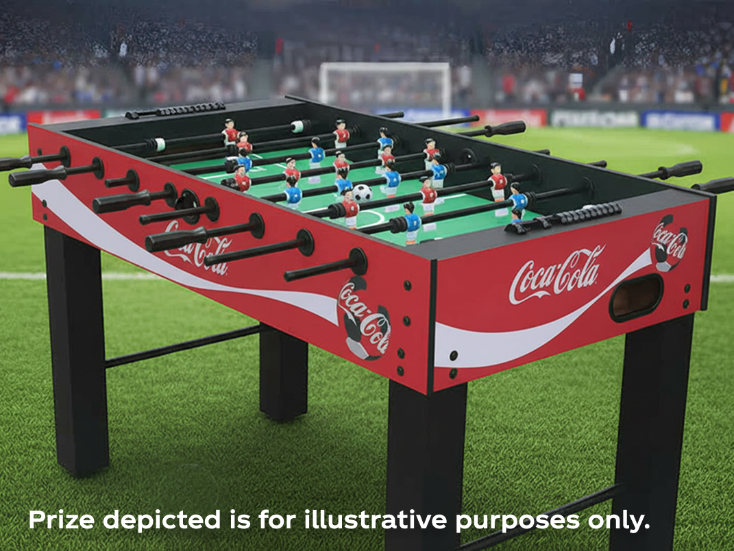 Coca-Cola branded foosball table on soccer pitch highlighting foosball champion prize for Match Day Getaway sweepstakes