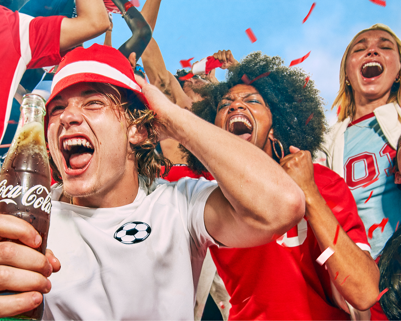 Group of soccer fans cheering with a glass coca-cola bottle