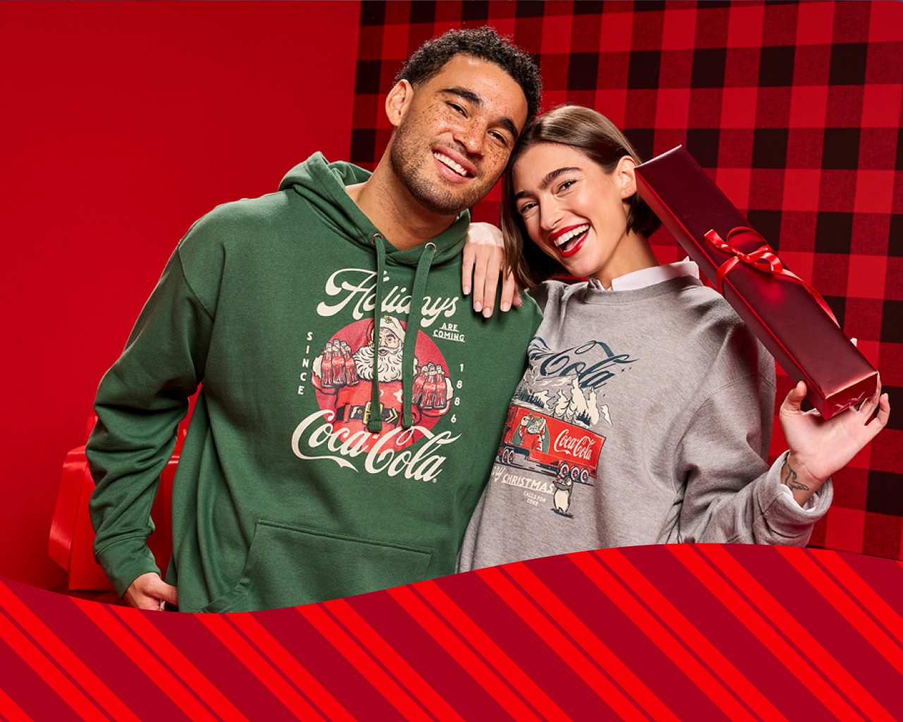 a man and a women wearing Coca-Cola merchandise from the Coke Store