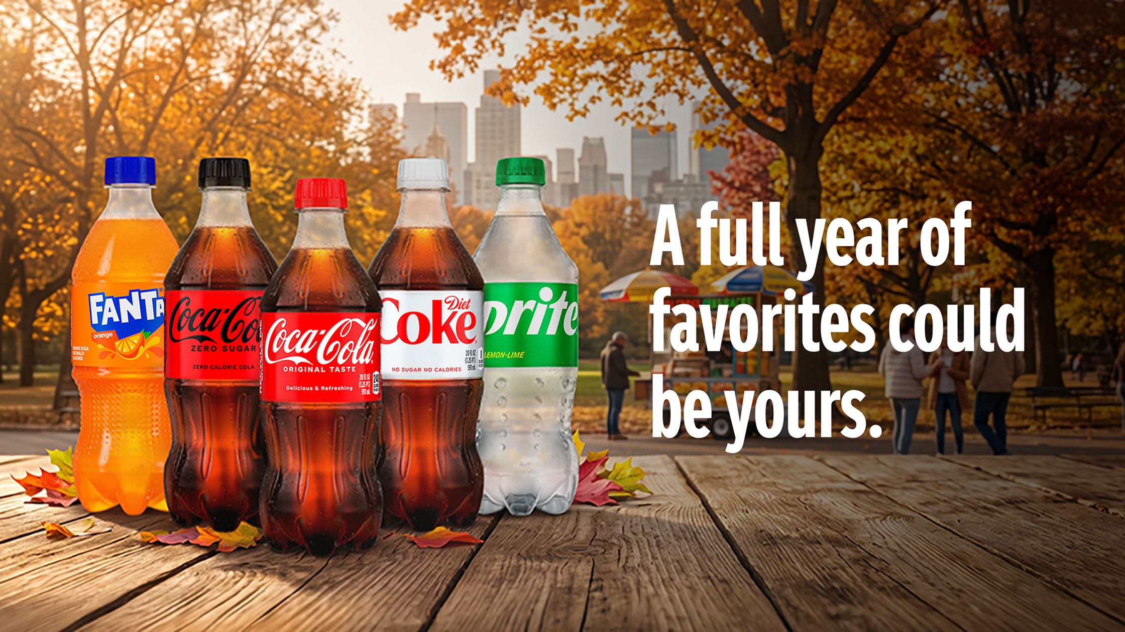 Assorted Coca-Cola products on an autumn park table promoting a sweepstakes to win a full year of favorites.