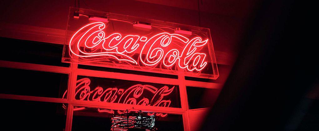A red neon Coca-Cola sign