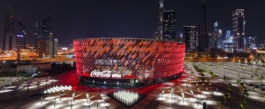 View of Coca-Cola Arena at night with city lights on the background