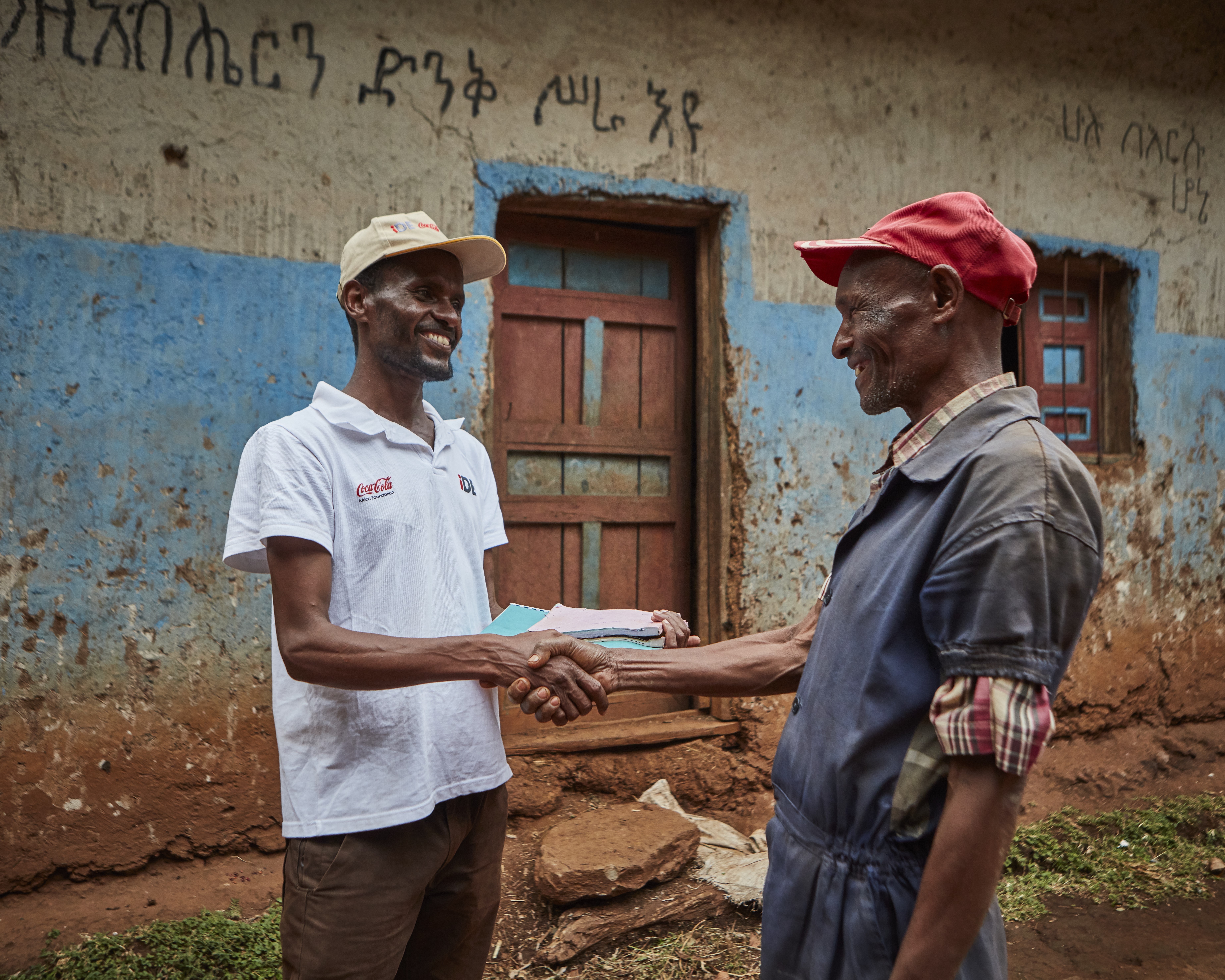 A Coca-Cola employee and local in Sodo Ethiopia shake hands