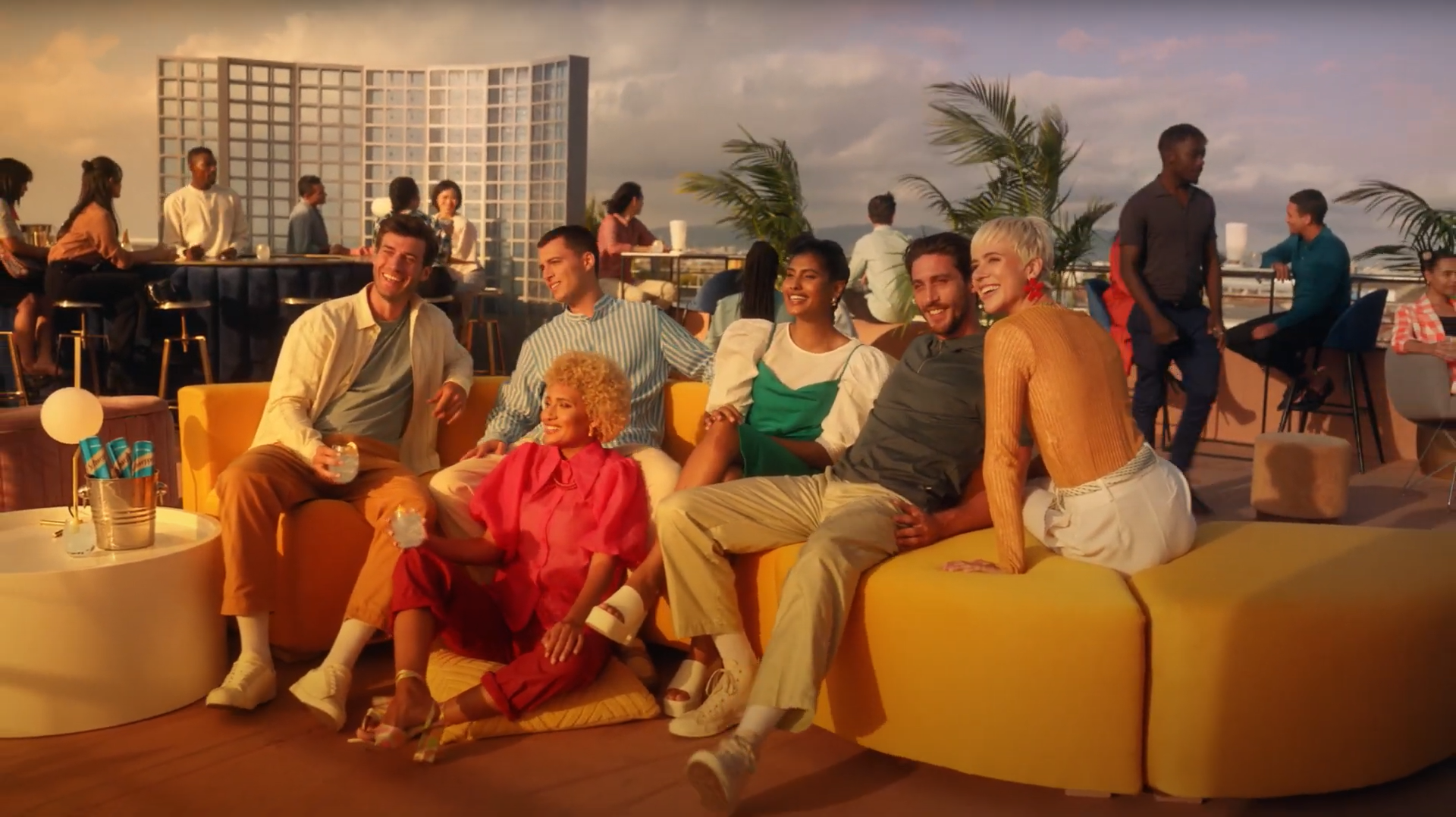 Group of friends enjoying the sunset with Schweppes.
