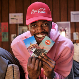 Man holding 2 limited merch